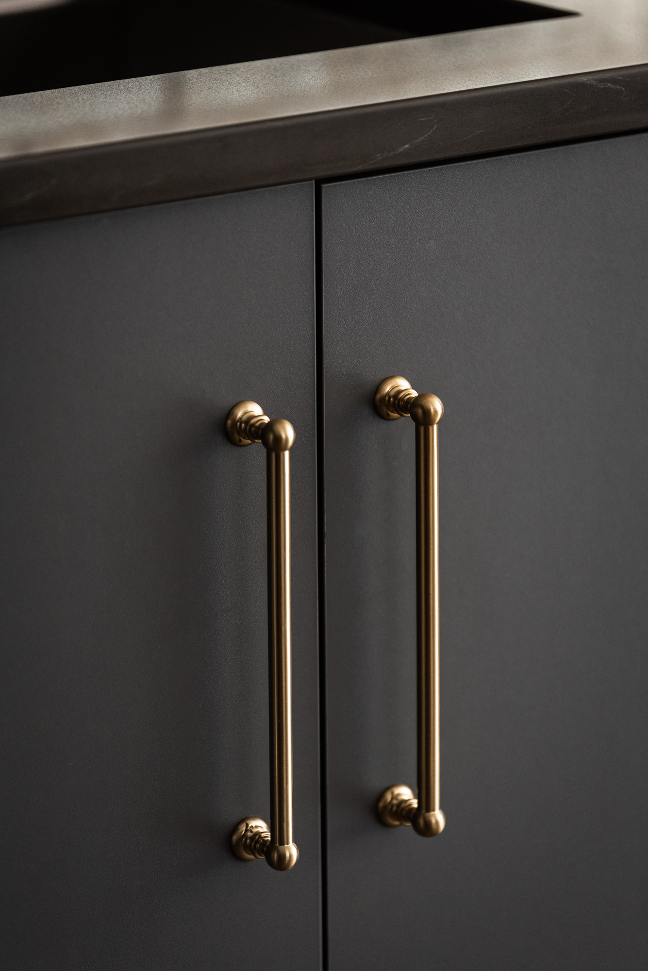 Gray cabinets with brass door pulls